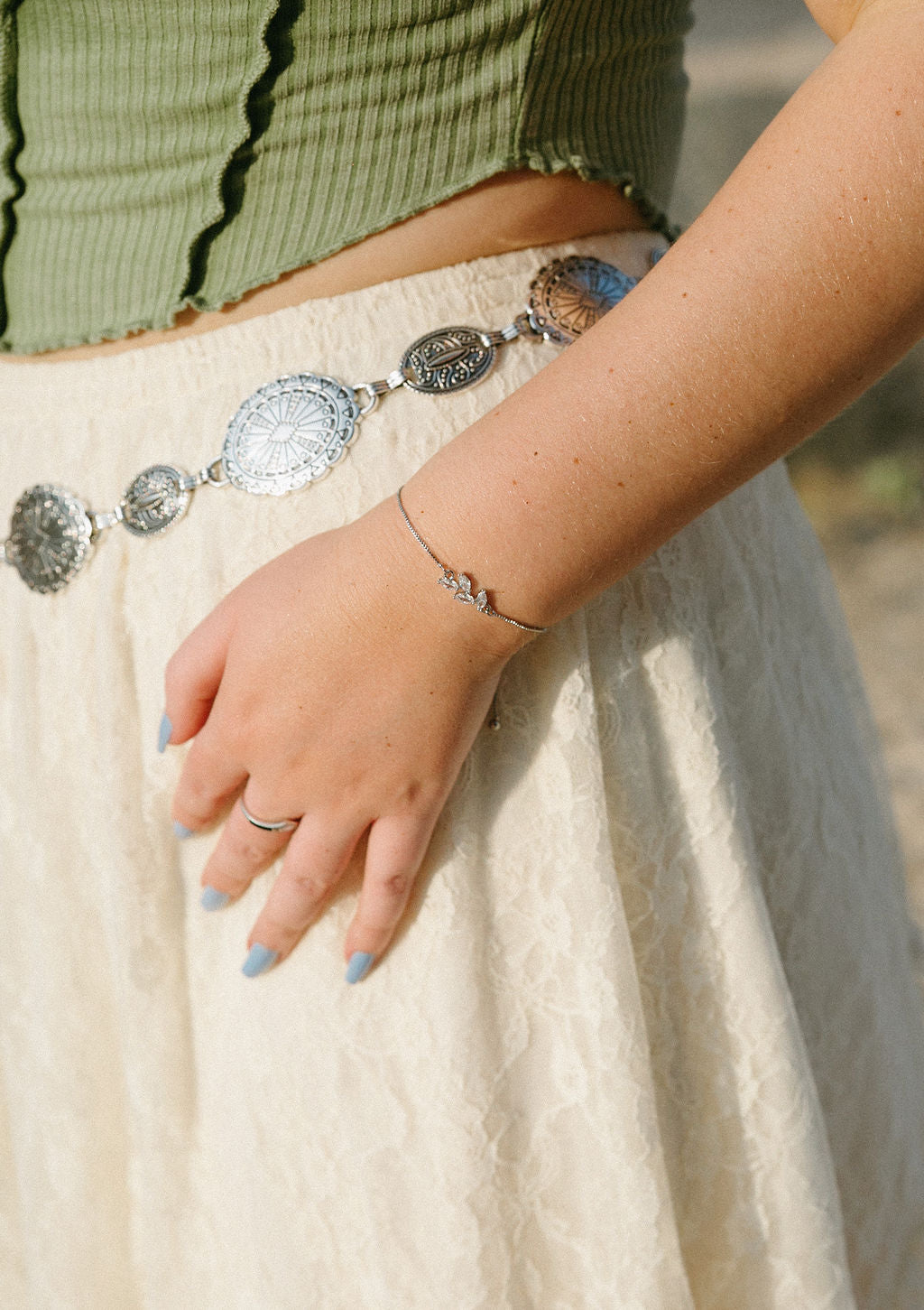 Minimal silver bracelet worn with neutral outfit, delicate everyday jewelry styling