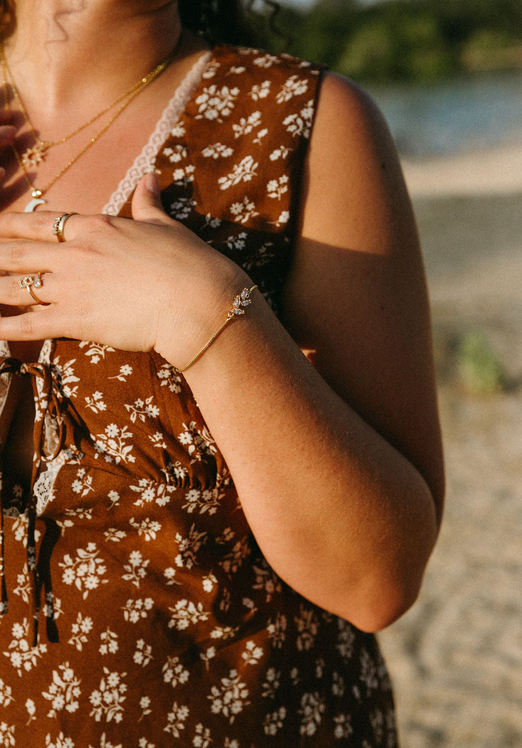 Dainty gold floral bracelet worn on wrist, feminine everyday jewelry styling