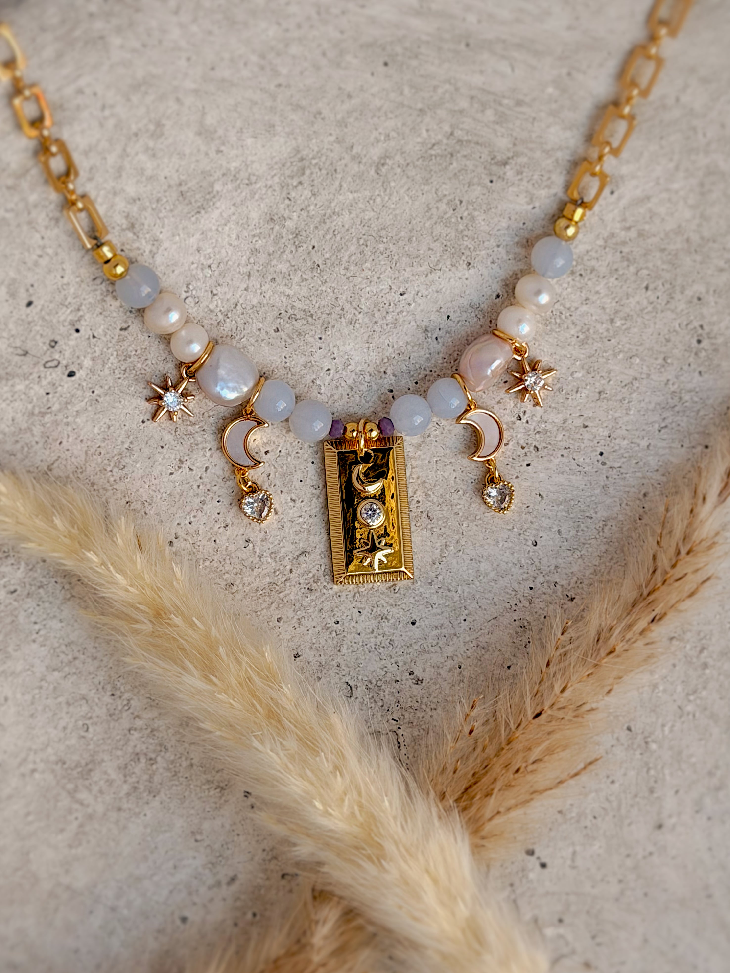 Handmade one-of-a-kind Moon Phase beaded charm necklace featuring freshwater pearls, natural gemstones, moon and star charms, and an 18-inch gold paperclip chain by Rising Soul Jewelry.