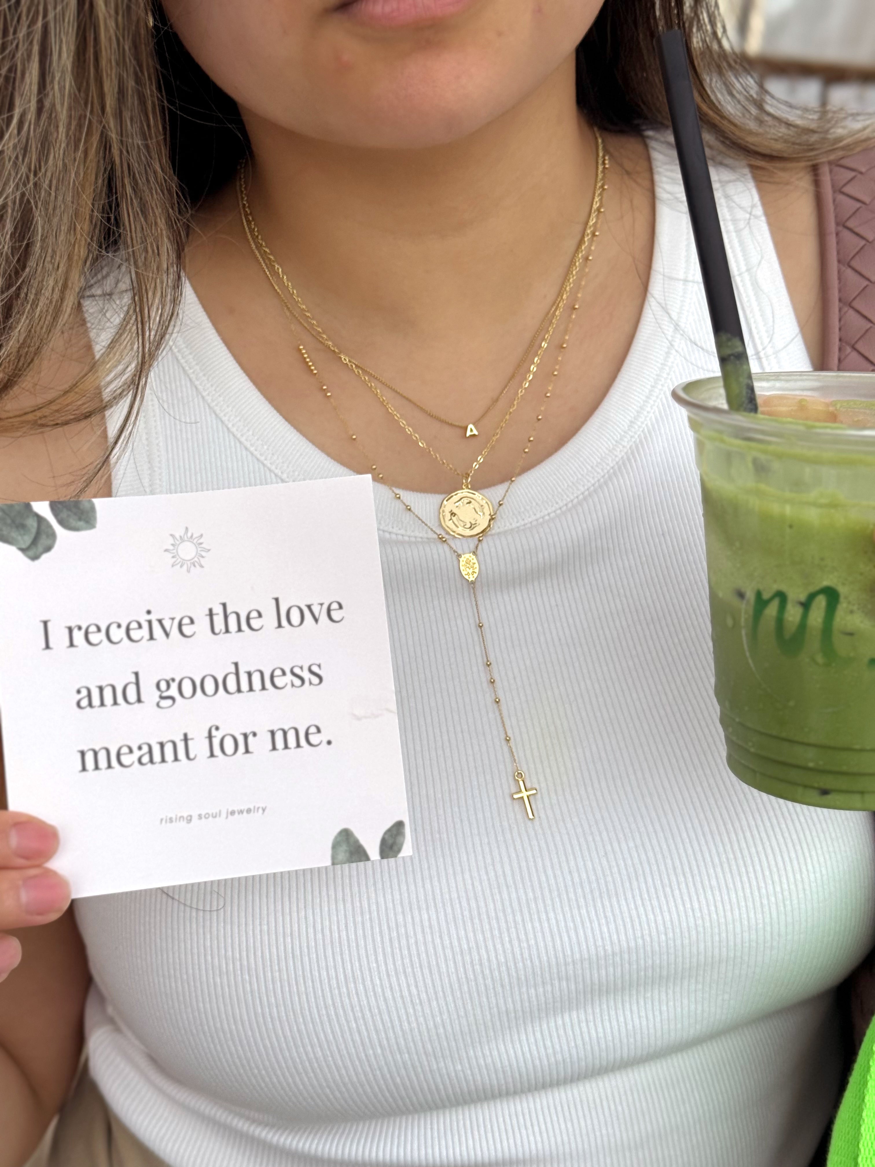 Gold zodiac necklace worn daily with affirmation card, meaningful jewelry for self expression