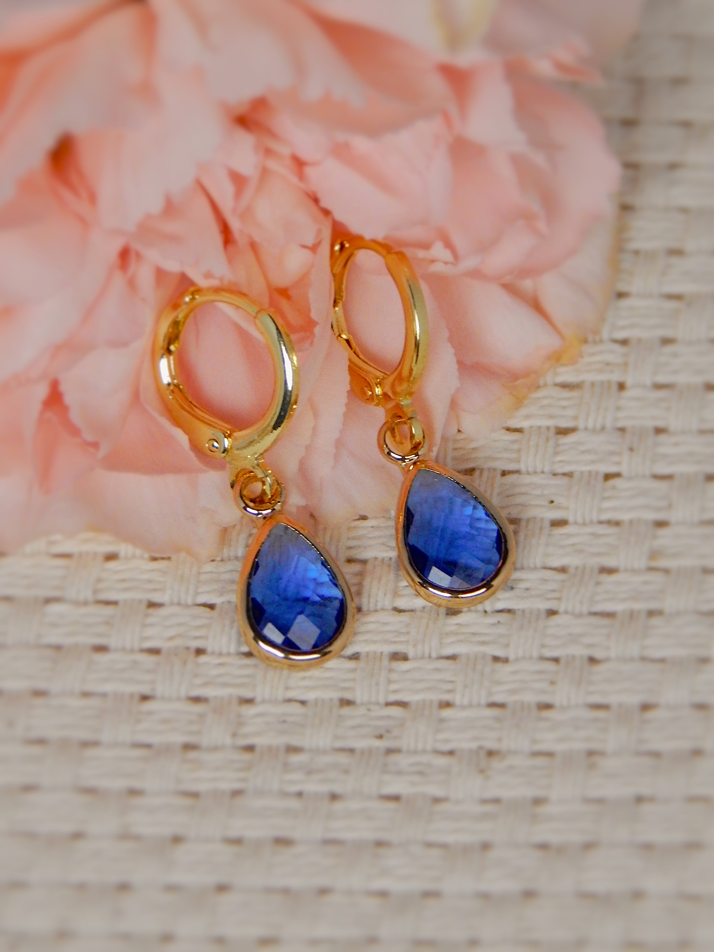 Gold huggie earrings with blue teardrop gemstone drop, bold colorful jewelry