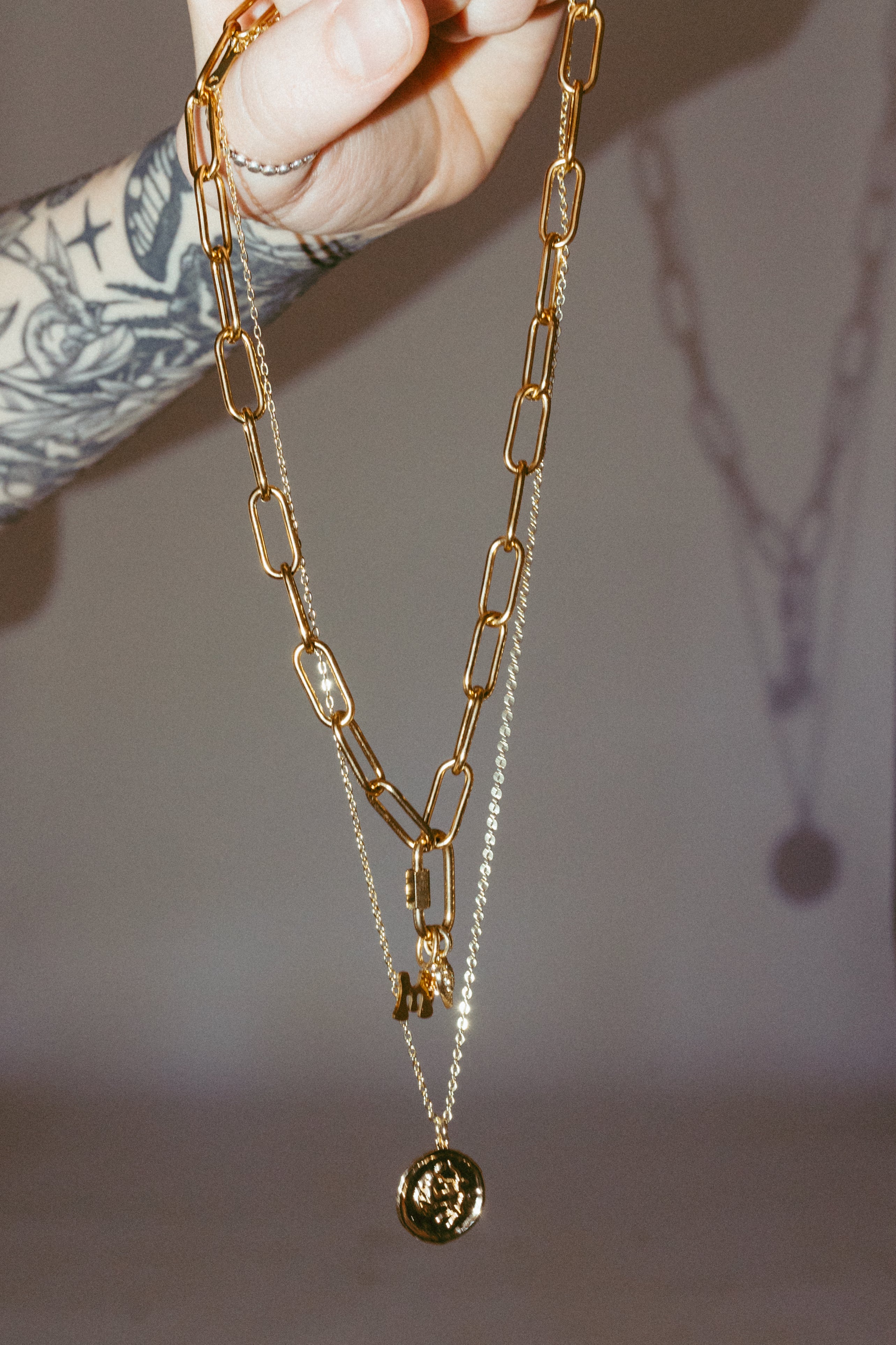 Gold zodiac necklace layered with chain detail, dainty celestial jewelry styling