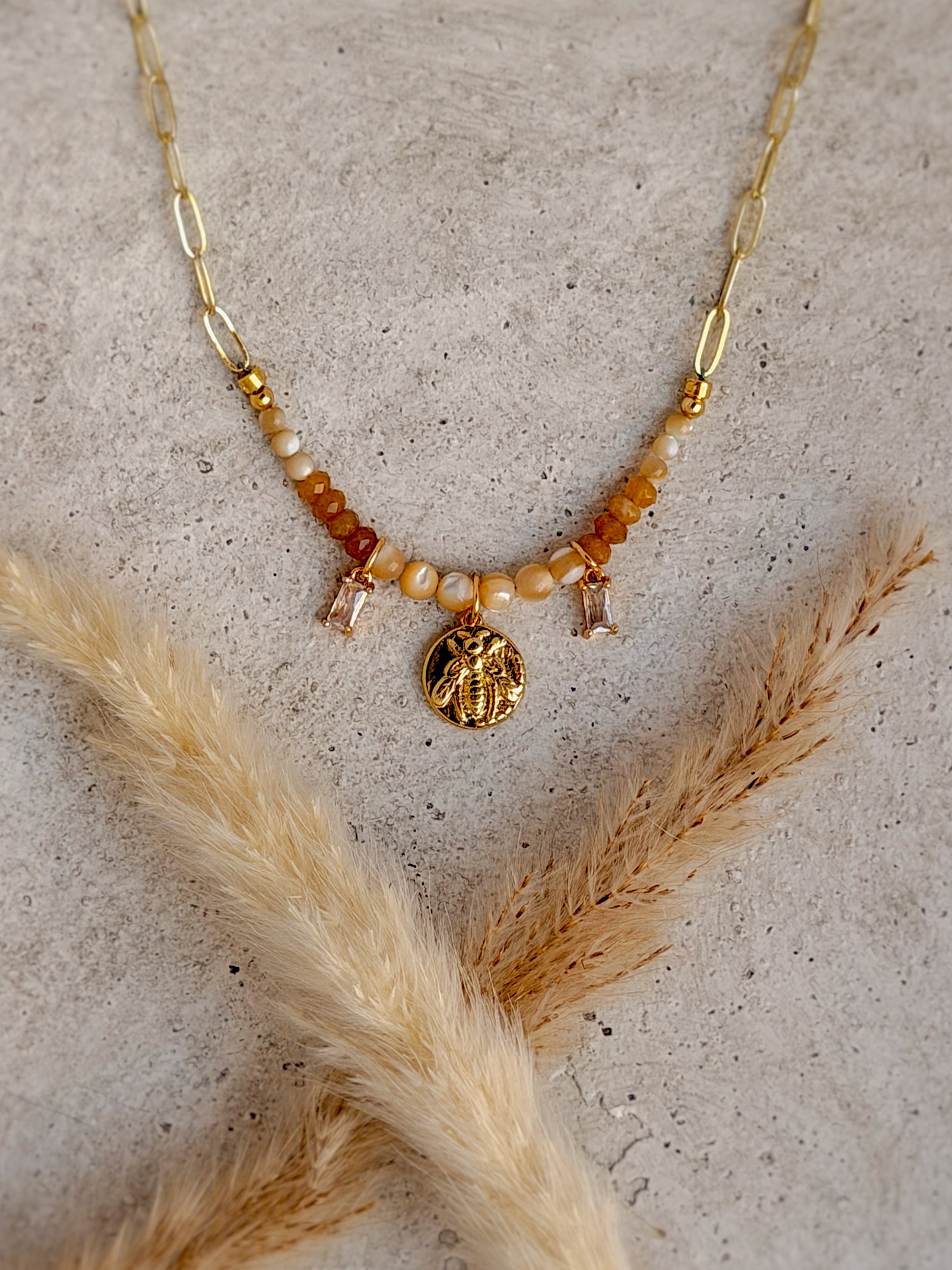 Handmade one-of-a-kind Bee beaded charm necklace featuring natural honey-toned gemstones, sparkling crystal accents, and an 18-inch gold paperclip chain by Rising Soul Jewelry.