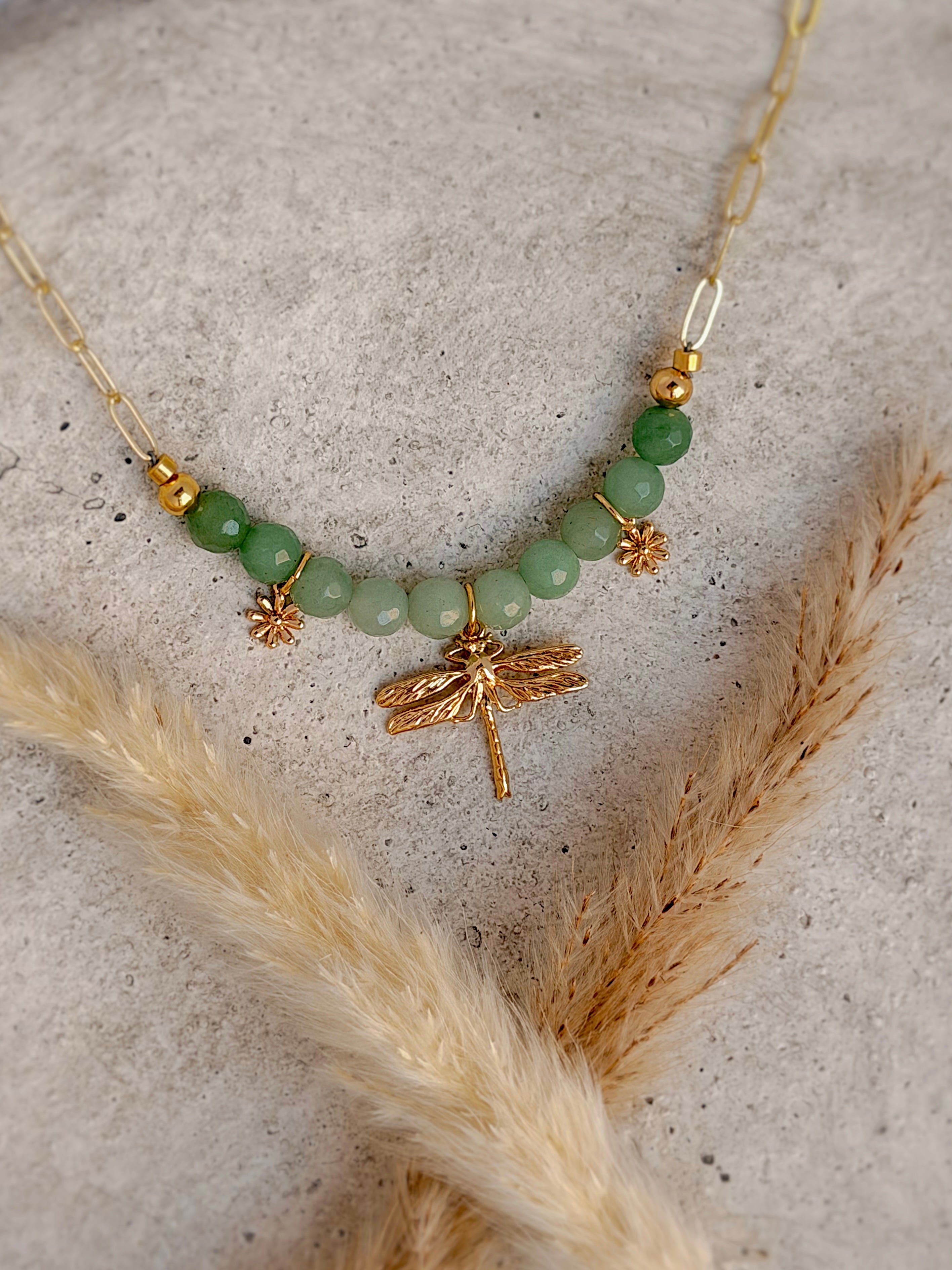 Handmade one-of-a-kind dragonfly beaded charm necklace featuring natural green gemstones, floral charms, and an 18-inch gold paperclip chain by Rising Soul Jewelry.