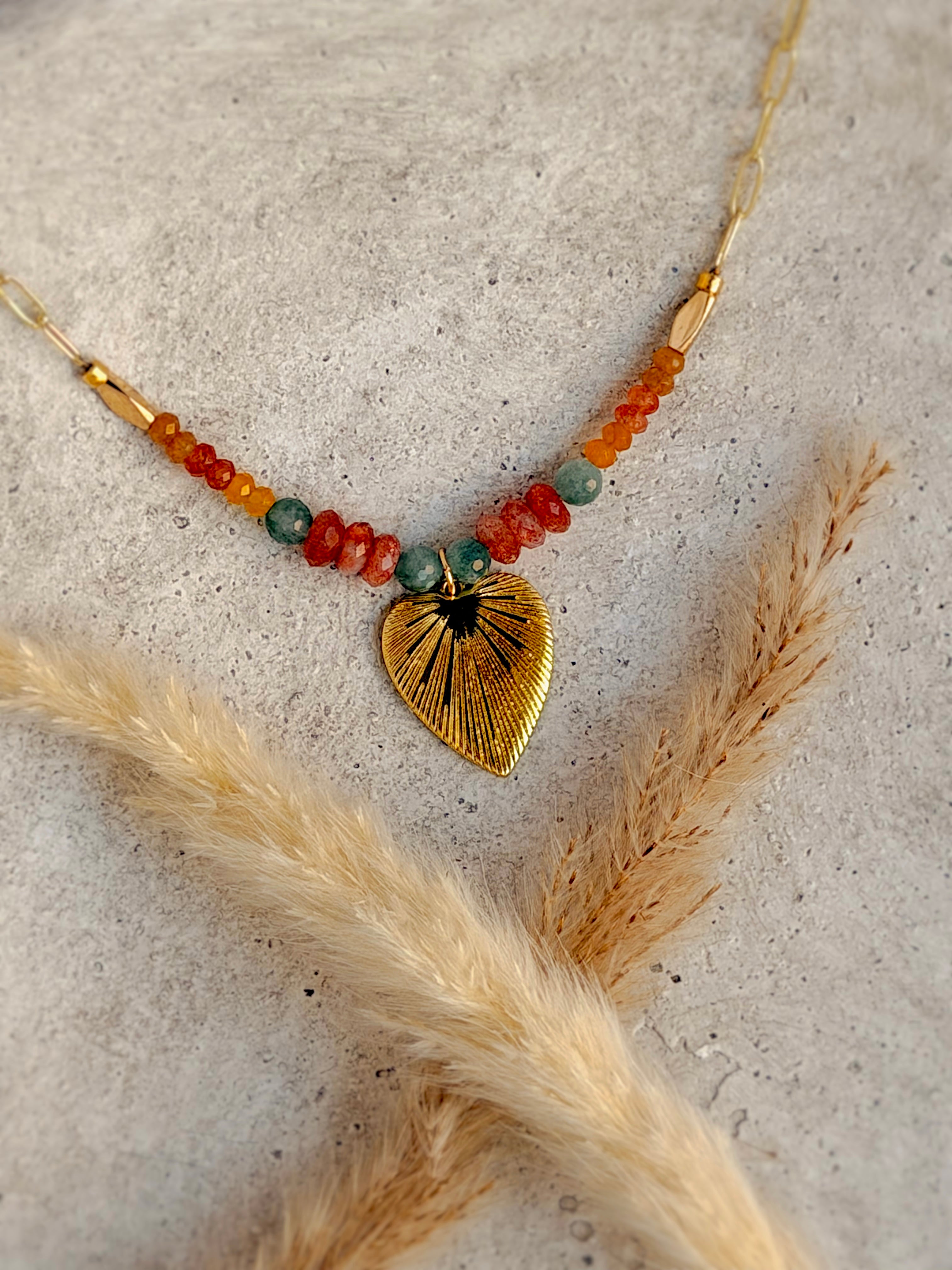 One of a Kind Wild Heart Necklace with natural amber and teal gemstones, textured gold heart charm, and 20-inch gold paperclip chain handcrafted by Rising Soul Jewelry.