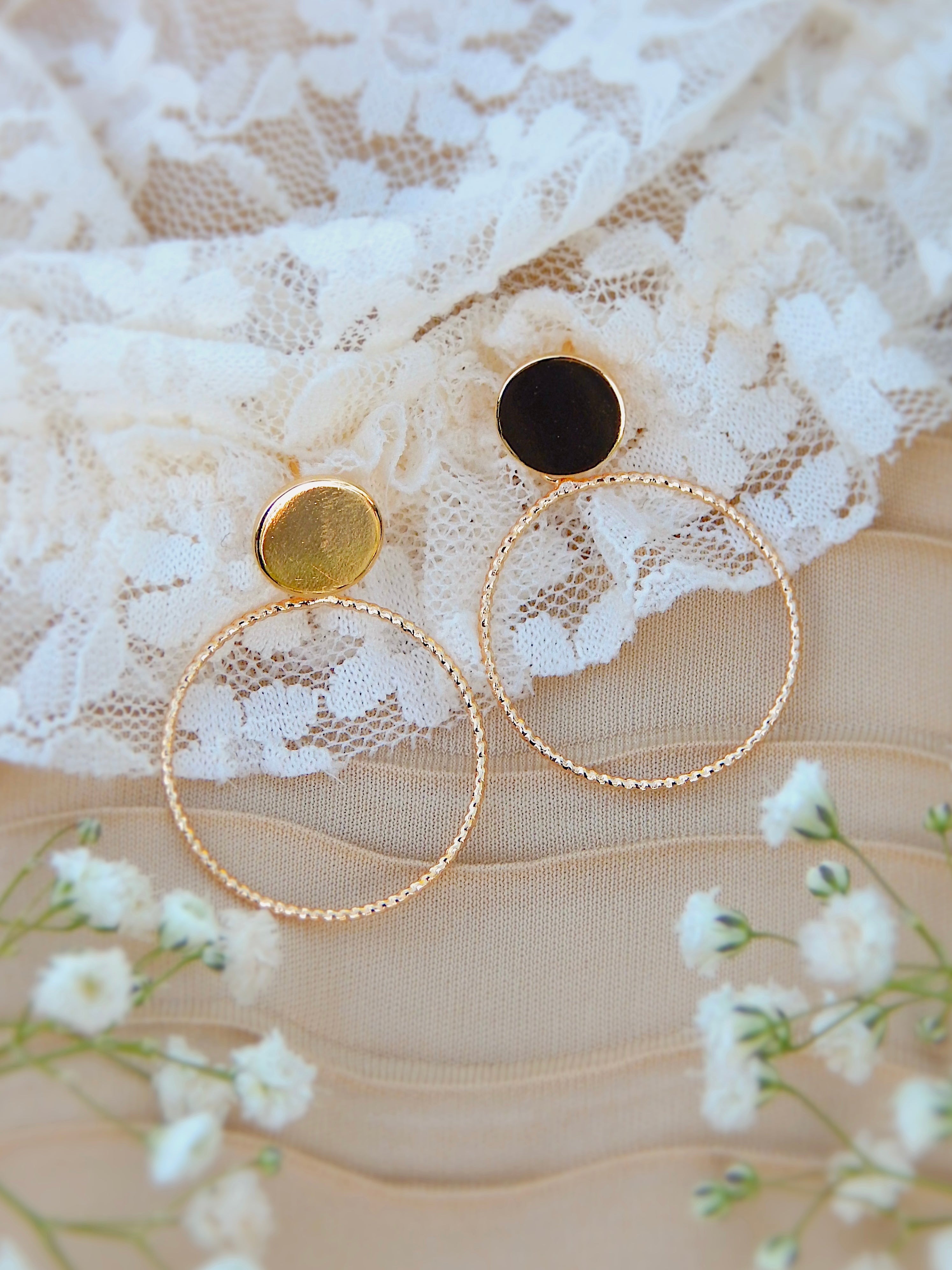 Gold circle stud hoop earrings with textured hoops on lace background