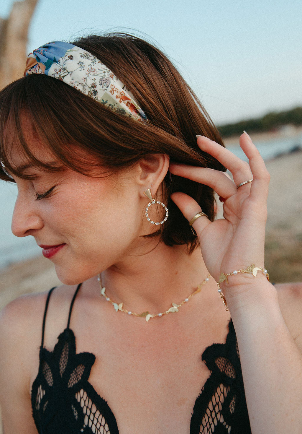 Woman wearing gold circle drop earrings with sparkling cubic zirconia, elegant statement jewelry shown in close-up